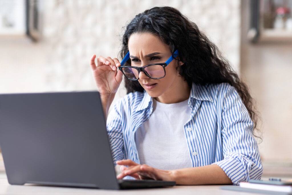 Woman straining at her screen